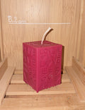 Bougie artisanale cubique de 92g avec gravures répétées du mot LOVE et de petits cœurs en relief, design moderne et minimaliste en cire naturelle.