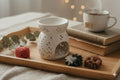 Ensemble de luxe comprenant un brûleur en porcelaine blanche et trois grands fondants de cire sculptés (frangipanier, marguerite, cœur) pour une décoration raffinée.